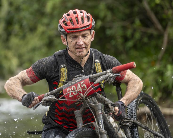 Male Cyclist carrying bike